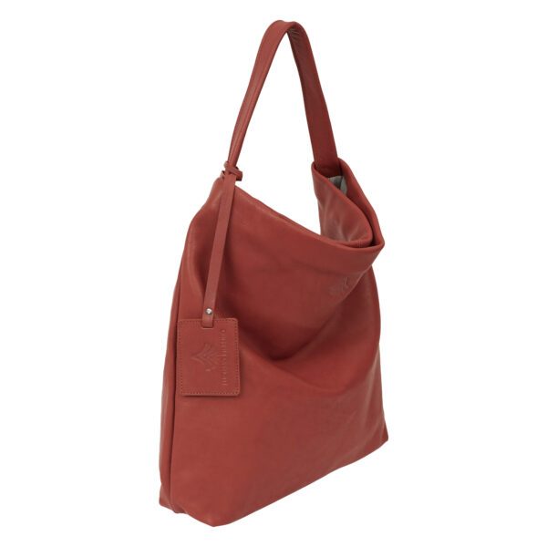 Bolsa Hobo atacama de couro (terrracota), compacta, com alça de ombro integrada.
